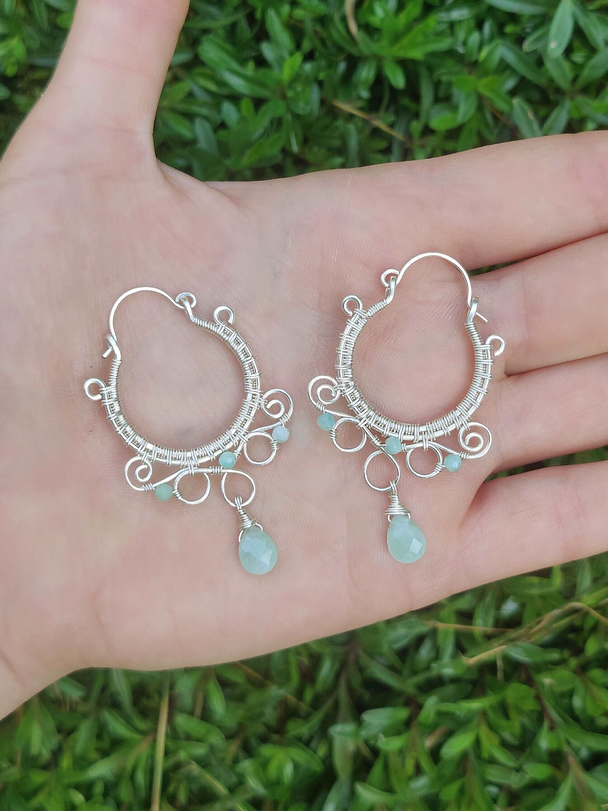 Wire wrapped silver hoop earrings. Designed with intricate swirls, woven frame and amazonite crystal dangles. 